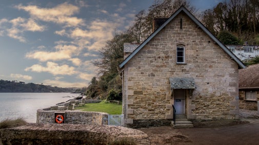 The side of Durgan Beach Cottage, and the garden it shares with Durgan Quay Cottage, on the bank of the Helford Estuary, Cornwall